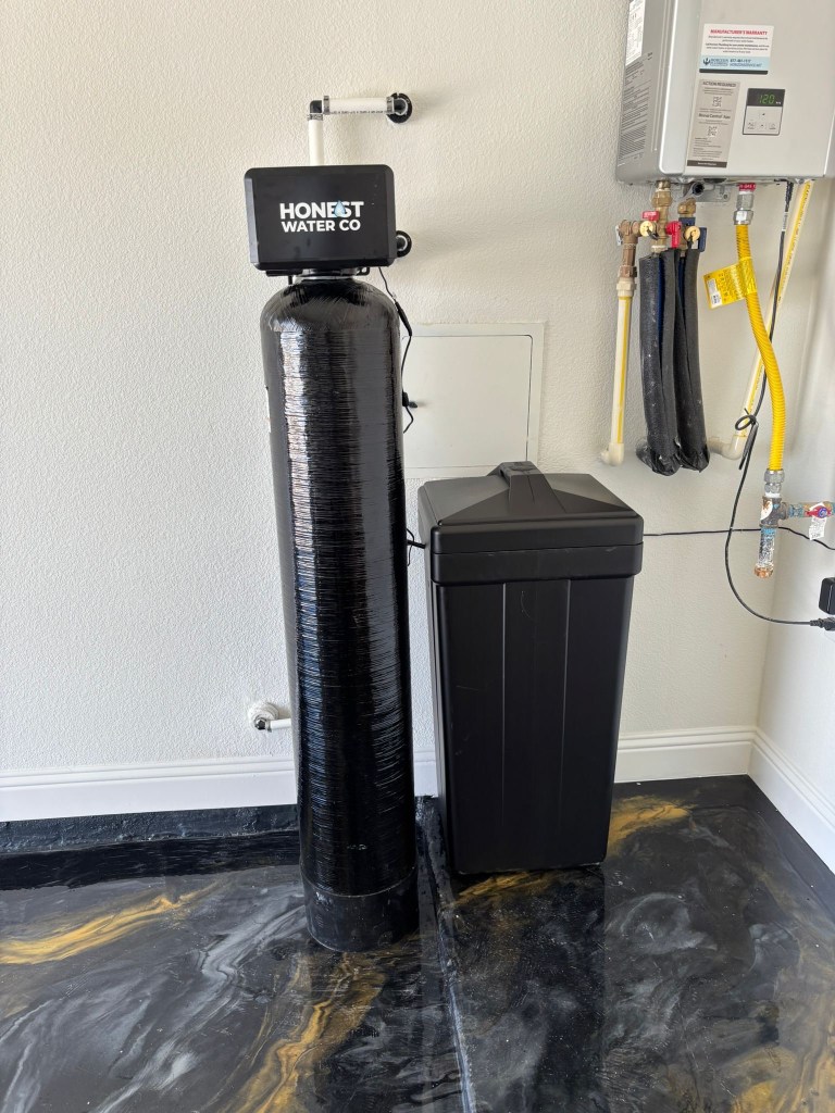 Water softener installed in an Ottawa basement with a neatly routed drain line